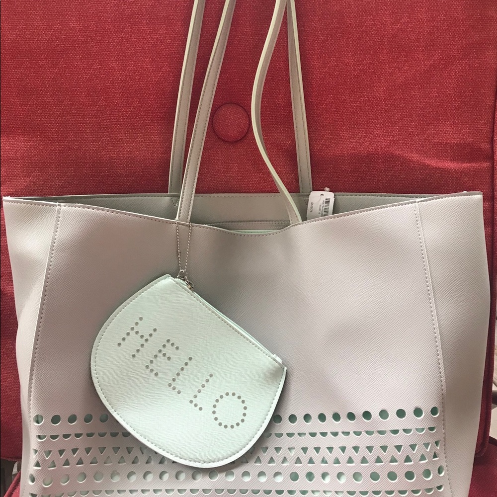 Large Soft green handbag with cosmetics bag shown.